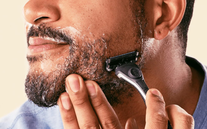 A Person Shaving with a Dollar Shave Club Razor