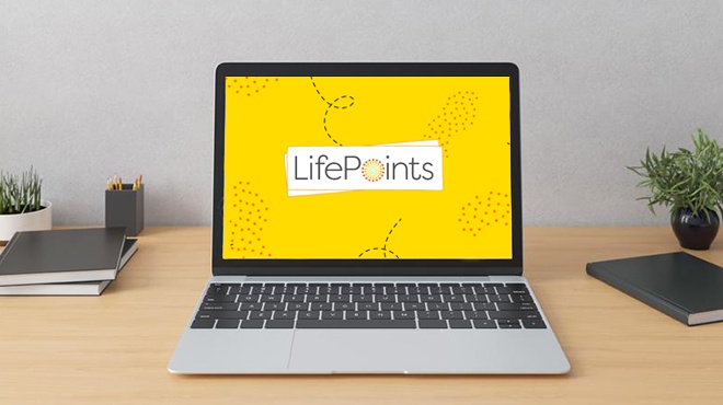 Laptop with LifePoints Logo on the Background on top of a Work Desk