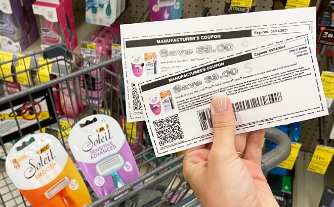 A Hand Holding Coupons at Walgreens