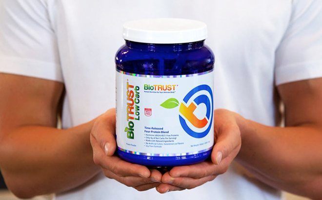 A Person Holding a Can of BioTrust Low Card Protein