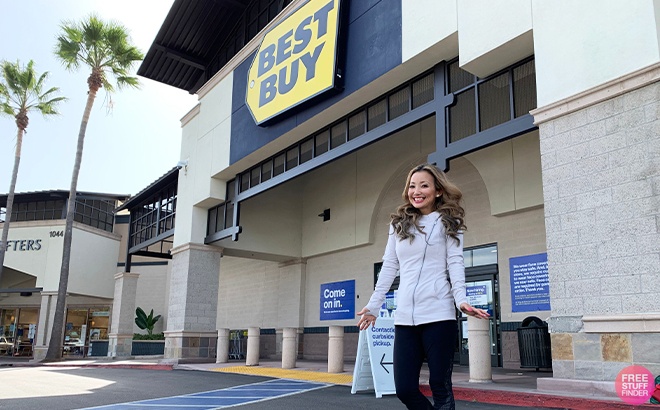 A Woman Smiling and Standing in Front of a Best Buy Store