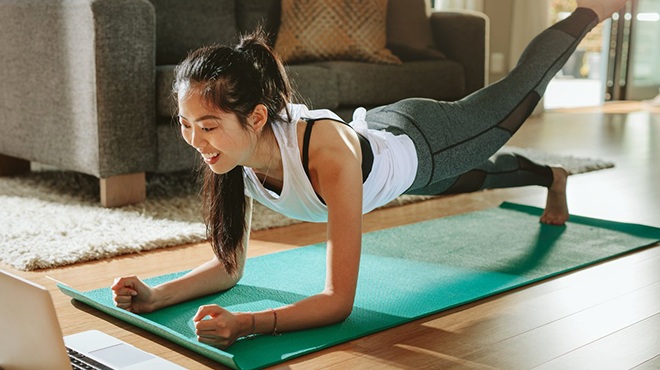 A Woman in the Middle of a Workout on a Yoga Mat