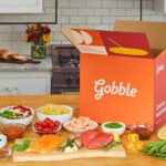 Opened Gobble Box on a Kitchen Counter next to Fresh Foods