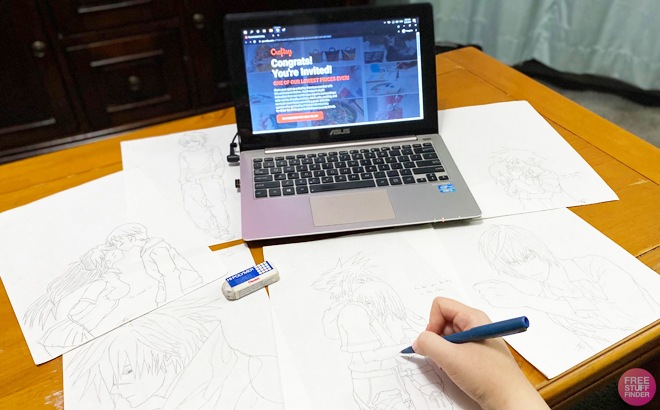 A Person Drawing Over One of Several Sketches Laid Out on a Desk