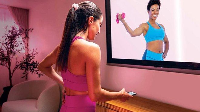 A Woman Working Out in Front of a TV