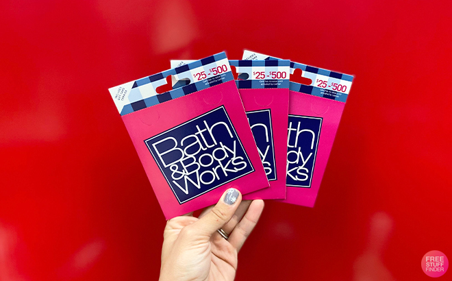 Hand Holding Three Bath & Body Works Gift Cards