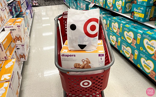 Target Baby Gift Bag on top of a Box of Diapers Inside a Shopping Cart at a Target Store
