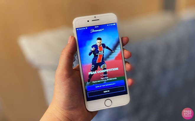 A Hand Holding a Phone with the Paramount Plus Login Page on the Screen