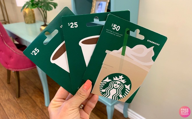 A Person Holding Starbucks Gift Cards