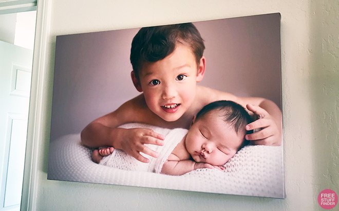A Canvas Print of a Boy and a Baby Girl Hung on a Wall