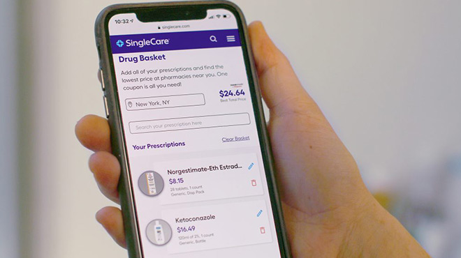A Person Holding a Phone with SingleCare on the Background
