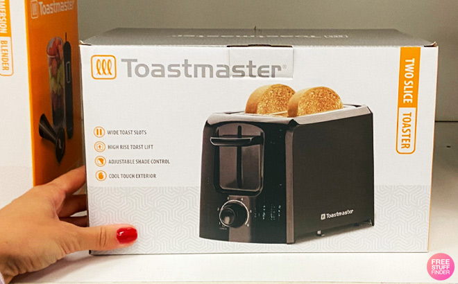 Hand Holding Toastmaster 2-Slice Toaster on a Store Shelf 