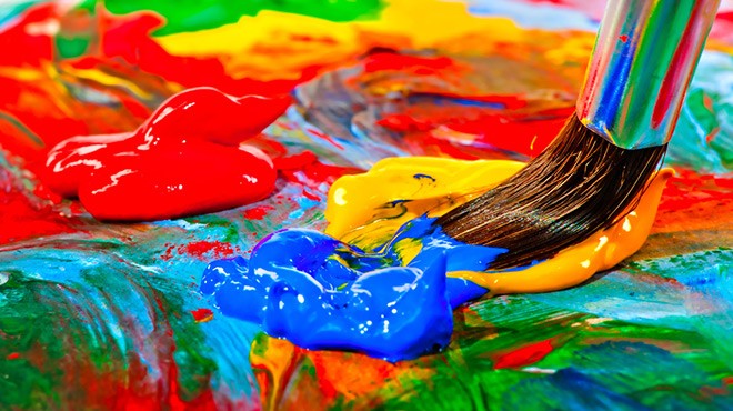 A Palette Containing a Blue and Yellow Paint Being Scooped by a Brush