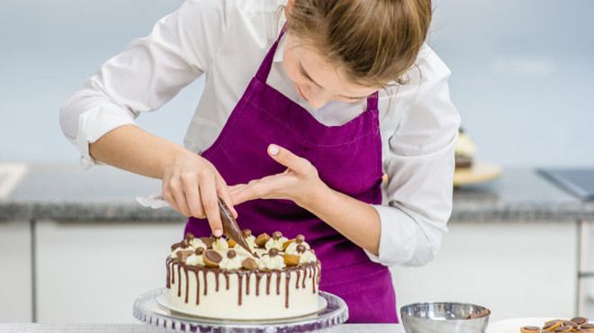 A Person Decorating a Cake