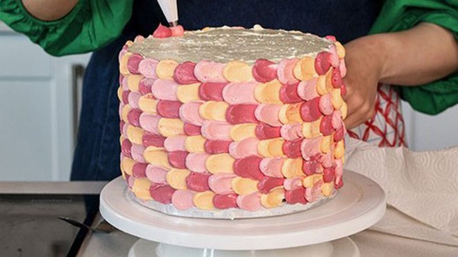 A Person Decorating a Cake