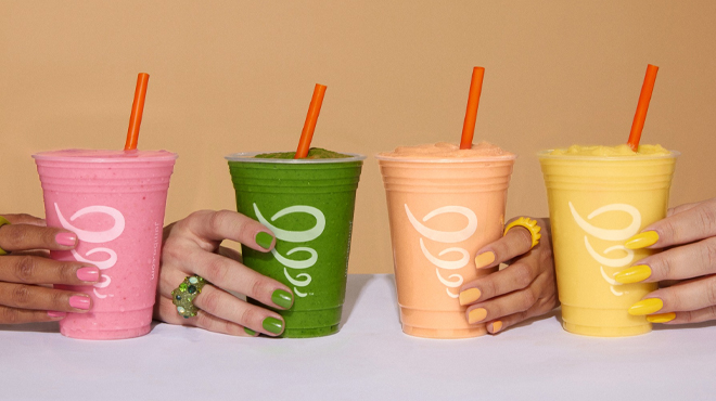 Hands holding four Jamba Juice