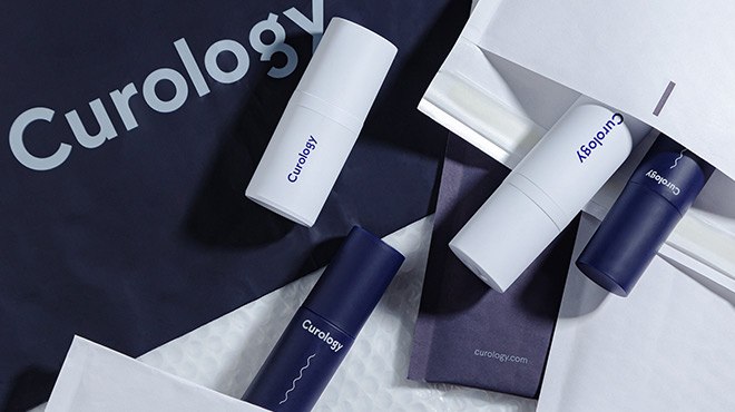 Four Curology Skincare Items Laid Down on a Few Curology Envelopes
