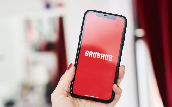 hand holding a phone with grubhub delivery service app