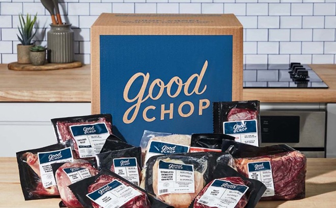 Good Chop Box next to Pieces of Meat on a Kitchen Counter