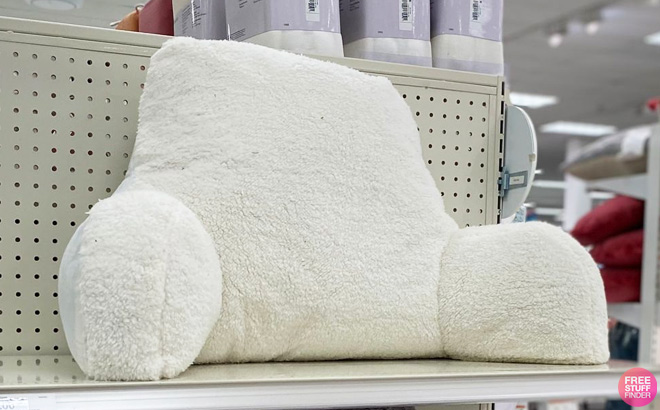 Sherpa Bed Rest Pillow on a Store Shelf