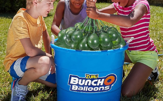 Three Children Playing with a Bunch of Water Balloons
