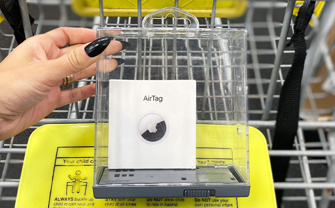 A Hand Holding a Transparent Box with Apple AirTags in It