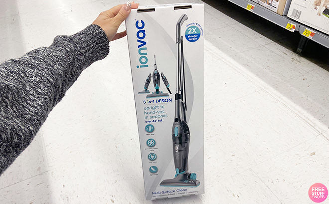 Hand Holding the Box of IonVac 3-in-1 Lightweight Corded Stick Vacuum