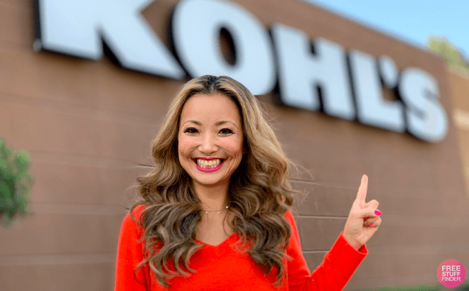 A Woman Smiling and Pointing at the Store Sign in Front of a Kohl's Store