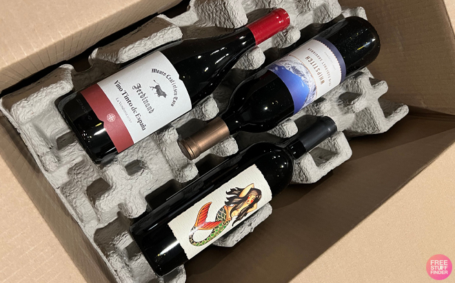 Three Bottles of Red Wine Laid Down in a Cardboard Box