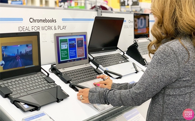 A Woman Trying Out a Laptop at a Store