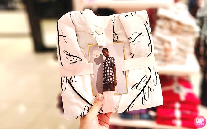 A Hand Holding a Victoria's Secret Flannel Pajama Set