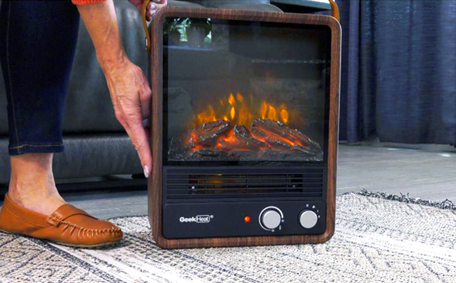Hand Holding Geek Heat 1500 Watt Flickering Flame Crackle Heater