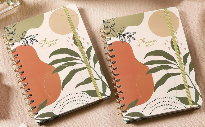 TWO Weekly Monthly Hardcover Planners with Tabs on a Tabletop
