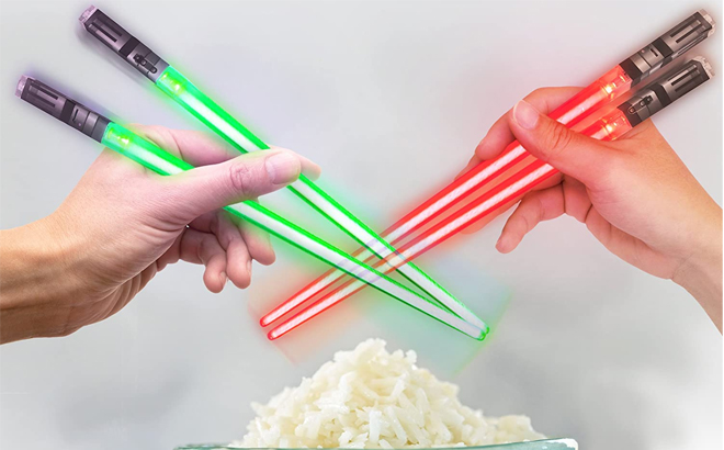 Two Hands Holding Star Wars Light-Up Lightsaber Chopsticks