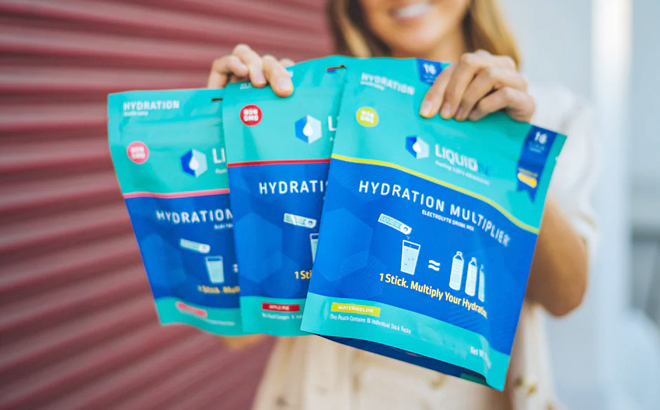 Woman Holding Liquid I.V. Hydration Multipliers in Various Flavors