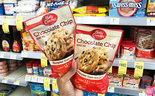 Hand Holding Betty Crocker Chocolate Chip Cookie Mix in Front of a Store Shelf