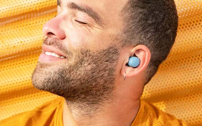 Man using JLAB Go Air Pop Bluetooth Earbuds Gray Man using JLAB Go Air Pop Bluetooth Earbuds Gray