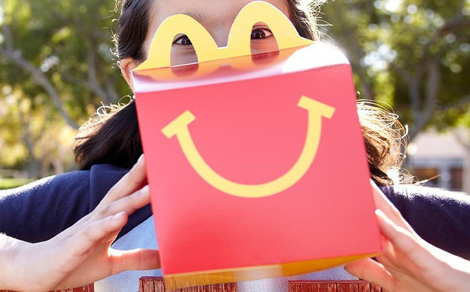 A Child Holding a McDonald's Happy Meal Box