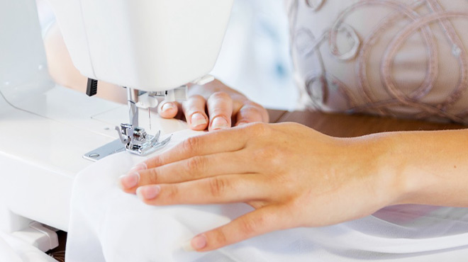 A Person Sewing on a Sewing Machine
