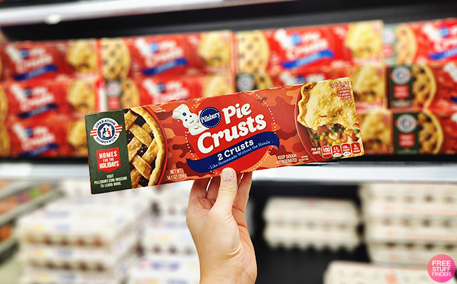Hand Holding Pillsbury Pie Crusts 2-Pack in Front of a Store Shelf