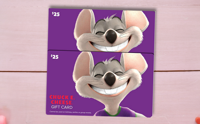 Two Counts of Chuck E Cheese 50 Value Gift Cards on a Table