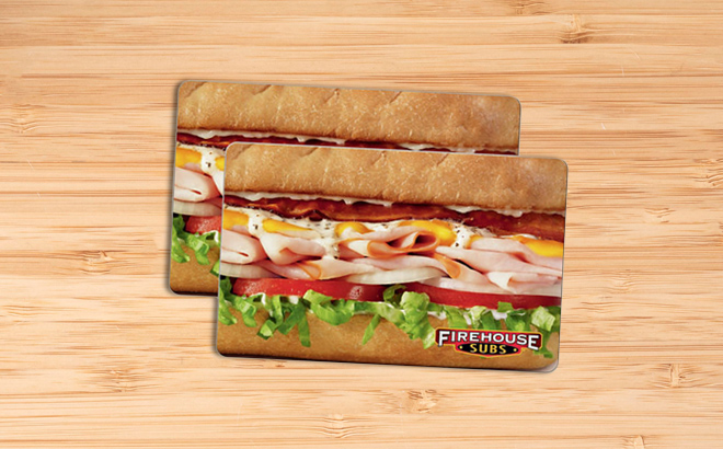 Two Counts of Firehouse Subs Gift Cards on a Wooden Table