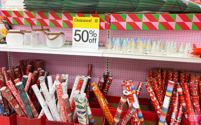 Various items mini glass christmas trees gift wraps on the shelf