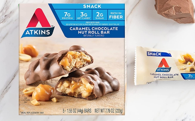 Atkins Snack Bar 5 Count in Caramel Chocolate Nut Roll Flavor on a Marble Counter
