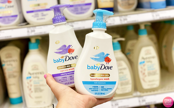 Hand Holding Baby Dove Sensitive Skin Care Calming Moisture on the Left, and Rich Moisture on the Right in Front of a Store Shelf