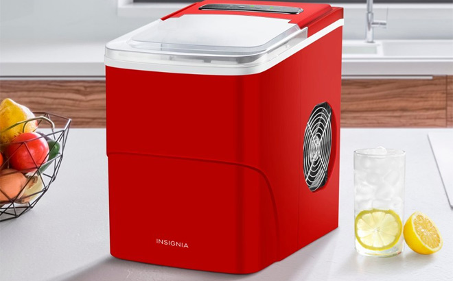 Insignia 26 Lbs Portable Icemaker in red on kitchen counter