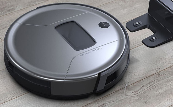 bObsweep Robot Vacuum next to Charging Station on a Wooden Floor