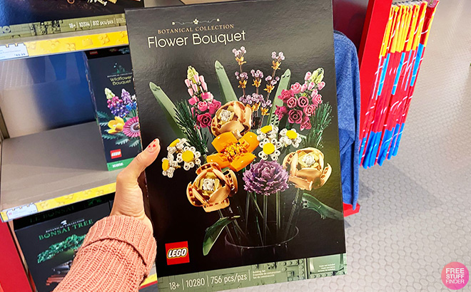 Hand Holding LEGO Flower Bouquet 756-Piece Set in front of a Store Shelf
