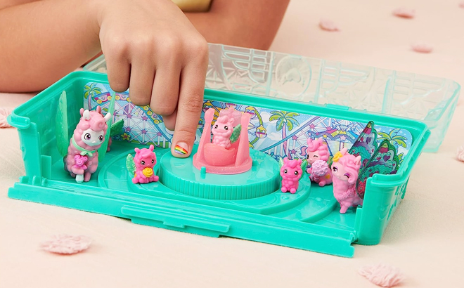A Child Playing Hatchimals CollEGGtibles Llama Family Playset