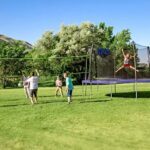 A Family Playing on the Skywalker Round Sports Arena with Trampoline and Enclosure